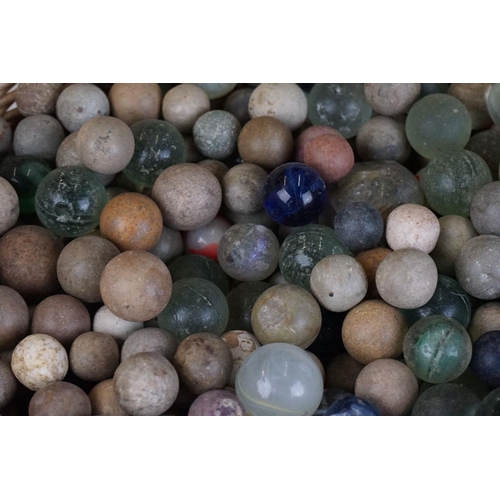 344 - A collection of mixed marbles together with a wooden solitaire board.