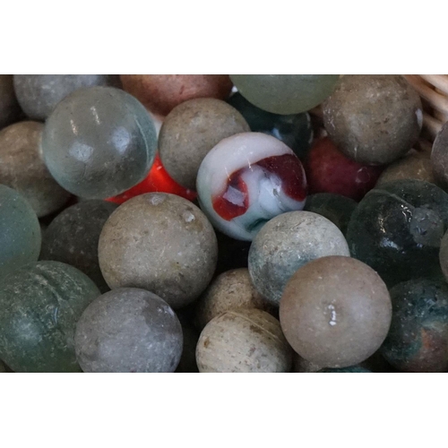 344 - A collection of mixed marbles together with a wooden solitaire board.