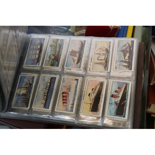 445 - A large collection of stamps, coins, cigarette cards, tea cards and first day covers contained in tw... 