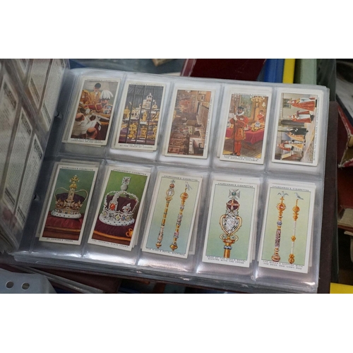 445 - A large collection of stamps, coins, cigarette cards, tea cards and first day covers contained in tw... 