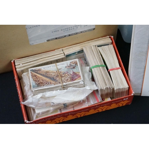 445 - A large collection of stamps, coins, cigarette cards, tea cards and first day covers contained in tw... 