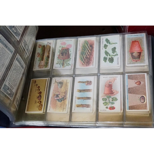 445 - A large collection of stamps, coins, cigarette cards, tea cards and first day covers contained in tw... 