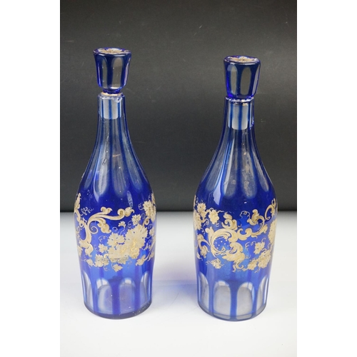 11 - Glass Blue Flash Cut Decanter and Stopper, 37cm high together with a Pair of Blue Flash Cut Decanter... 