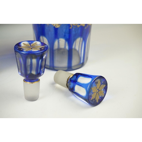 11 - Glass Blue Flash Cut Decanter and Stopper, 37cm high together with a Pair of Blue Flash Cut Decanter... 