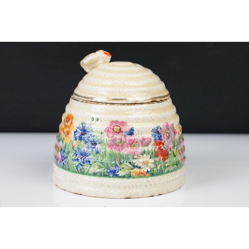 4 - Clarice Cliff Pottery Beehive Honey Pot in the Radiance pattern (damage to wing of bee), 11cm high