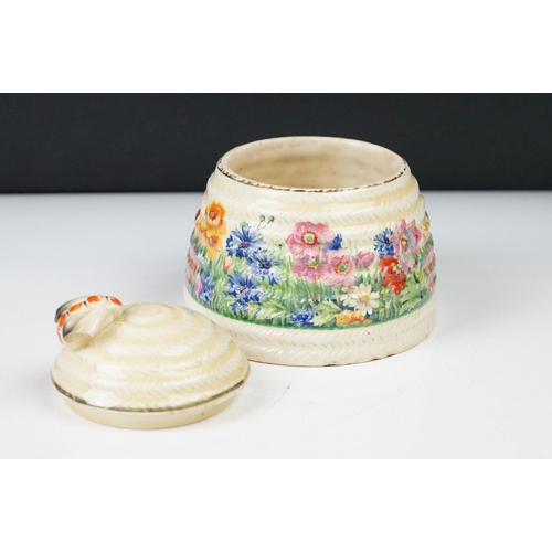 4 - Clarice Cliff Pottery Beehive Honey Pot in the Radiance pattern (damage to wing of bee), 11cm high