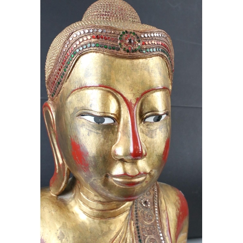 190 - Large South East Asian / Thai Wooden Buddha with a gilded and red lacquered finish, 56cm high