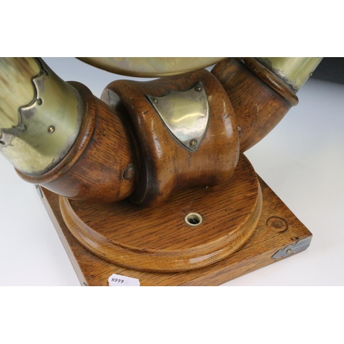 160 - Edwardian Oak and Horn dinner gong, the central brass gong supported by two bovine horns mounted upo... 