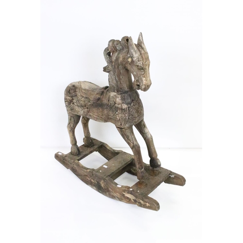 594 - Hardwood Rocking Horse, 71cm wide x 80cm high together with a Mid century Child's Pull-along Horse