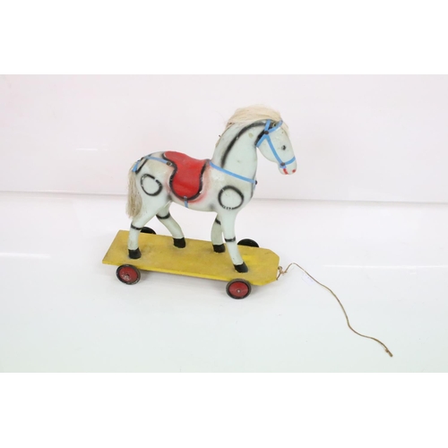 594 - Hardwood Rocking Horse, 71cm wide x 80cm high together with a Mid century Child's Pull-along Horse