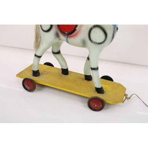 594 - Hardwood Rocking Horse, 71cm wide x 80cm high together with a Mid century Child's Pull-along Horse