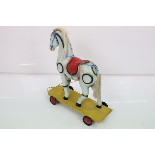 594 - Hardwood Rocking Horse, 71cm wide x 80cm high together with a Mid century Child's Pull-along Horse