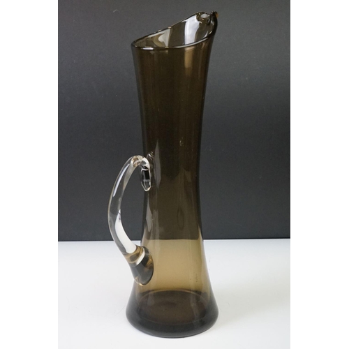 28 - Three pieces of Whitefriars glassware to include a tall Smoky Grey Martini jug by Peter Wheeler (36c... 