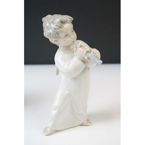 63 - Three Lladro Porcelain Figures to include a seated ballerina, girl holding lamb and an angel with fl... 