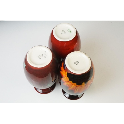 71 - Three Anita Harris Studio baluster vases to include an example with flame-like design on ox blood gr... 