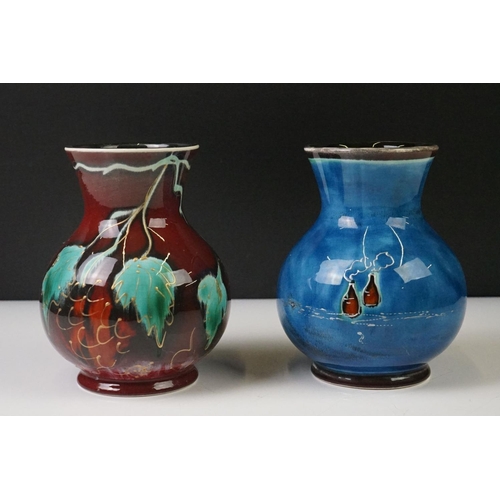 87 - Two Anita Harris Trojan shaped vases to include a trial vase with floral design on red ground, and a... 