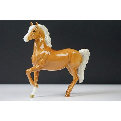 96 - Three Beswick porcelain figures to include a Palomino Prancing Arab Horse (17cm high), Brown Gloss h... 