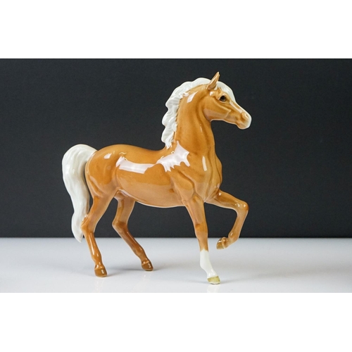 96 - Three Beswick porcelain figures to include a Palomino Prancing Arab Horse (17cm high), Brown Gloss h... 