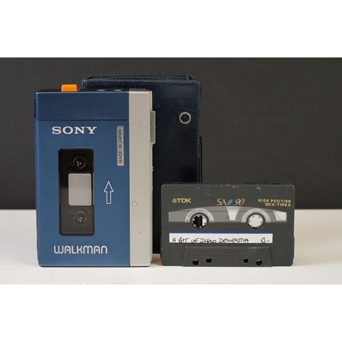 202 - A Vintage 1980's Sony Walkman personal cassette player complete with blue leather case.