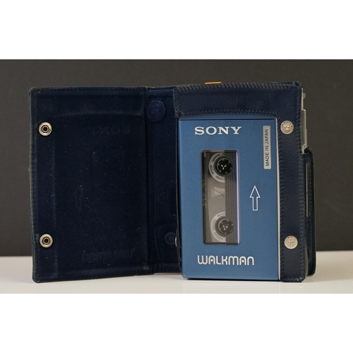 202 - A Vintage 1980's Sony Walkman personal cassette player complete with blue leather case.