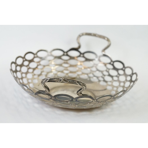 209 - A fully hallmarked sterling silver twin handled basket with pierced decoration, assay marked for Bir... 