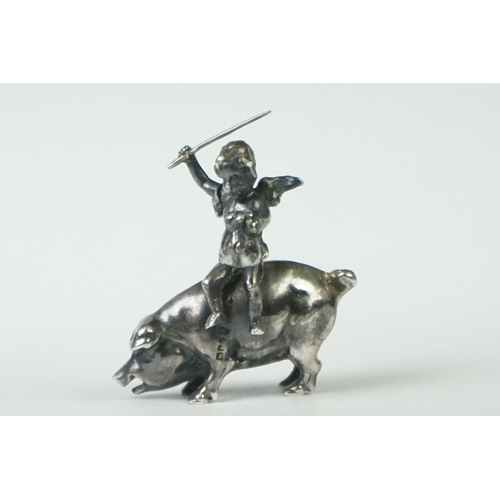 217 - A miniature fully hallmarked sterling silver figure of a cherub upon a pig, assay marked for Chester... 