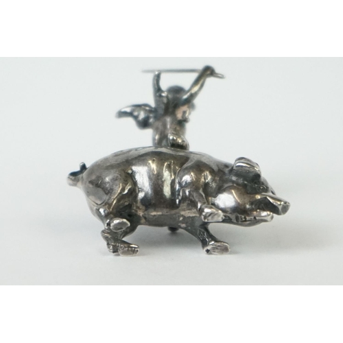 217 - A miniature fully hallmarked sterling silver figure of a cherub upon a pig, assay marked for Chester... 