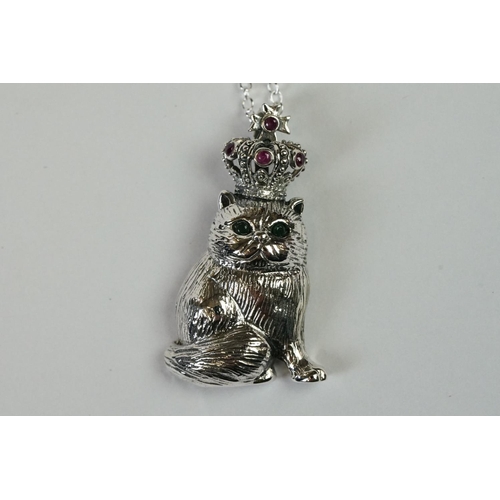 239 - Silver cat pendant necklace wearing a royal crown inset with rubies