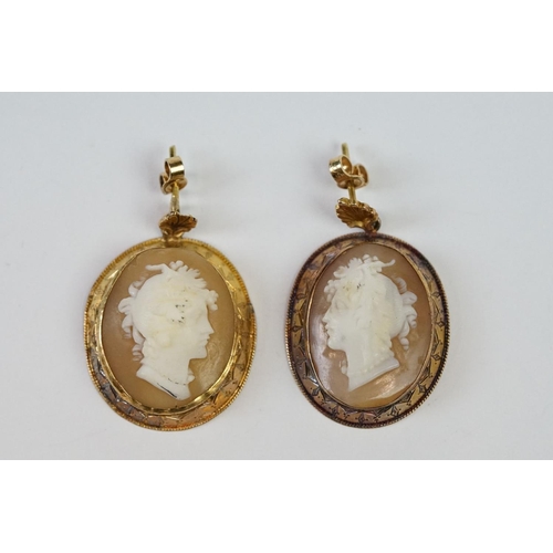 243 - A pair of yellow metal cameo earrings.