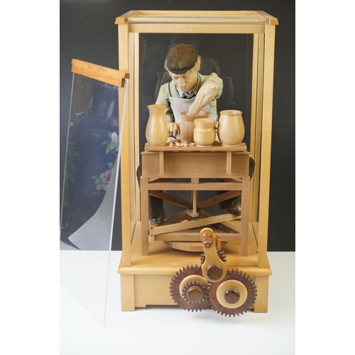 196 - Cased Mechanical Wooden Automaton of a Potter at his Wheel, the cased inscribed with a monogram, Pot... 