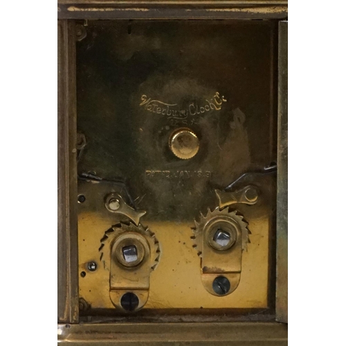 280 - A brass cased carriage clock with beveled glass panels and white enamel dial, complete with key.