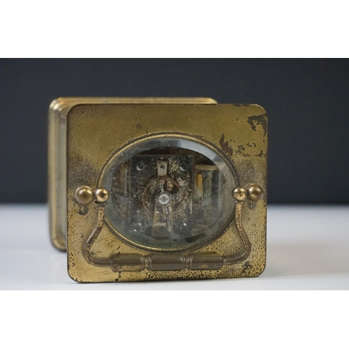 282 - A French carriage clock with bevelled glass panels and white enamel dial, complete with key.