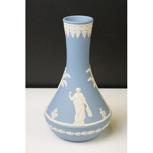 57 - Three pieces of Wedgwood Jasperware in pale blue to include a tapering vase (19cm high), urn-shaped ... 