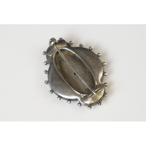 70 - A fully hallmarked sterling silver mourning brooch with rose and yellow gold decoration, assay marke... 