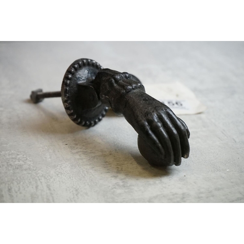 156 - Cast Iron Door Knocker and Striker modelled as a hand & orb (knocker measures approx 12.5cm long)