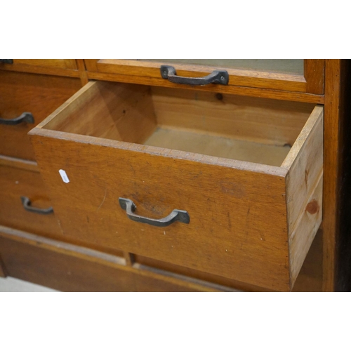 597 - Early 20th century Shop Oak Haberdashery Cabinet with two banks of eight glass fronted drawers (16 t... 