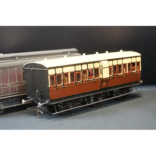 98 - 12 O gauge items of kit built coaches featuring trucks and vans, plastic & metal constructions, over... 