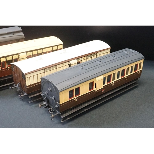 98 - 12 O gauge items of kit built coaches featuring trucks and vans, plastic & metal constructions, over... 