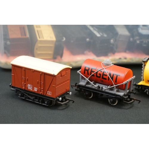 112 - Around 90 OO gauge items of rolling stock featuring tankers, vans and trucks to include Hornby, Tria... 