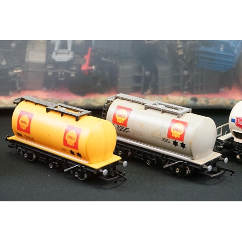 112 - Around 90 OO gauge items of rolling stock featuring tankers, vans and trucks to include Hornby, Tria... 