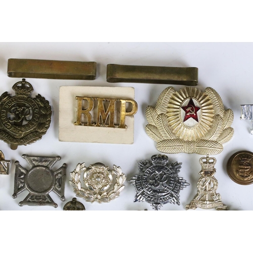 291 - A Collection Of Mainly British Military Regimental Cap Badges And Titles To Include The Royal Engine... 