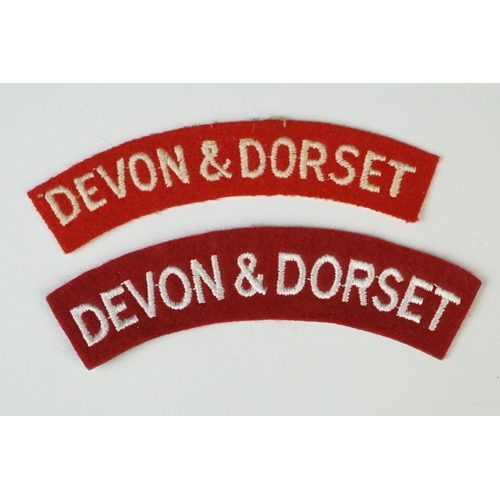 14 - A Collection Of Fourteen British Military The Devon & Dorset Regiment Badges To Include Shoulder Tit... 