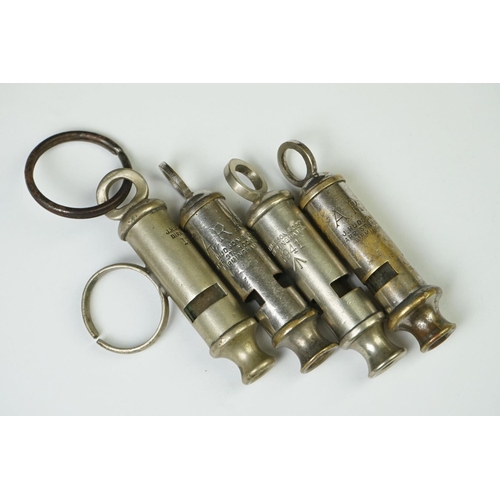 9 - A Collection Of Four British Military Issued Whistles To Include Air Raid Precautions Examples.