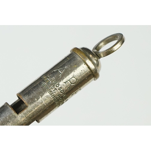 9 - A Collection Of Four British Military Issued Whistles To Include Air Raid Precautions Examples.