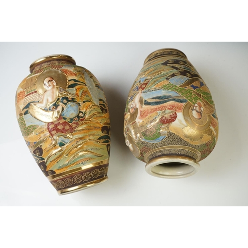 10 - Pair of 20th Century Japanese Satsuma vases of ovoid form, with relief moulded seated figures and be... 