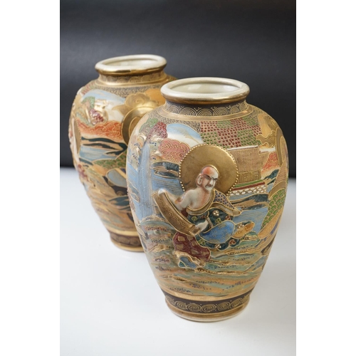 10 - Pair of 20th Century Japanese Satsuma vases of ovoid form, with relief moulded seated figures and be... 