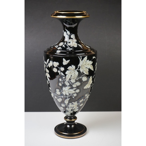 2 - Late 19th Century Black Urn-shaped Glass Vase enamelled with butterflies amongst leafy branches, wit... 