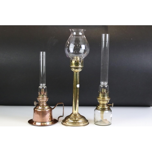 142 - Brass Spring Loaded Candle Holder with glass shade, 39cm high together with Two Oil Lamps with tall ... 