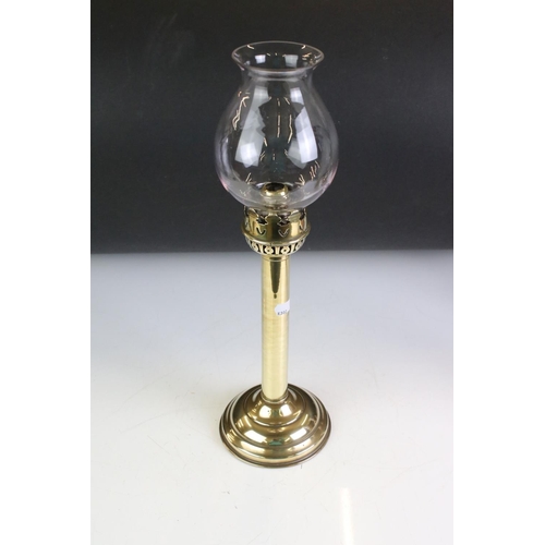 142 - Brass Spring Loaded Candle Holder with glass shade, 39cm high together with Two Oil Lamps with tall ... 