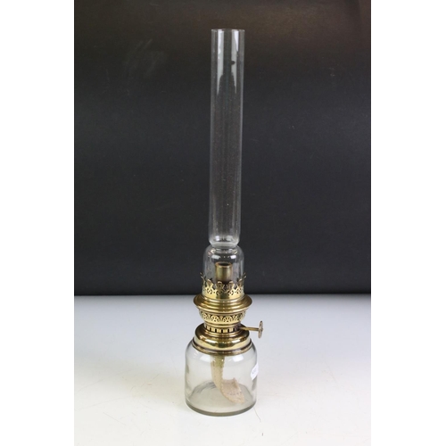 142 - Brass Spring Loaded Candle Holder with glass shade, 39cm high together with Two Oil Lamps with tall ... 